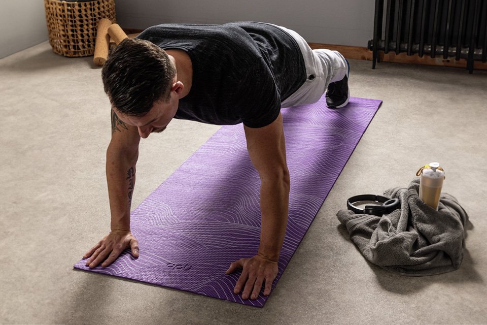 A man using Opti 6mm PVC Yoga Exercise Mat in purple colour.